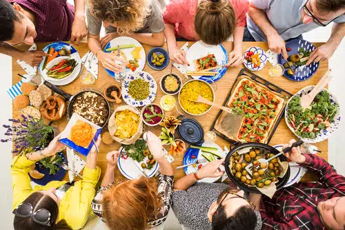 Gruppe von Menschen beim Essen von veganer Ernährung oder vegetarischer Ernährung.